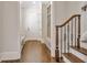 Hallway with hardwood floors, staircase, and built-in bench creating an inviting entryway at 4317 Oglethorpe Nw Loop, Acworth, GA 30101