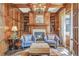 Stunning home office with wood paneling, built-in bookshelves, fireplace, and seating at 4317 Oglethorpe Nw Loop, Acworth, GA 30101