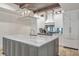 Kitchen island with white marble countertop, modern lighting, and stainless steel appliances at 4317 Oglethorpe Nw Loop, Acworth, GA 30101