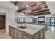 Elegant kitchen island features stainless sink and stone countertops, with exposed wood beam ceiling at 4317 Oglethorpe Nw Loop, Acworth, GA 30101