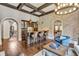 Open concept living room with bar area, fireplace, brick accent wall, and coffered ceiling at 4317 Oglethorpe Nw Loop, Acworth, GA 30101