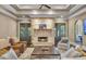 Cozy living room with stone fireplace, ceiling fan, and views to the exterior through French doors at 4317 Oglethorpe Nw Loop, Acworth, GA 30101