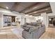 Open living space with stone fireplace, decorative beams, tile floors, and seamless flow to the kitchen at 4317 Oglethorpe Nw Loop, Acworth, GA 30101