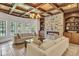 Sunlit living room featuring a stone fireplace, built-in shelving, and comfortable seating at 4317 Oglethorpe Nw Loop, Acworth, GA 30101