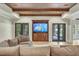 Cozy living room featuring a custom media center with cabinets and exposed beams on the ceiling at 4317 Oglethorpe Nw Loop, Acworth, GA 30101