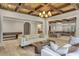 Open-concept living area with a coffered ceiling, neutral decor, and travertine flooring at 4317 Oglethorpe Nw Loop, Acworth, GA 30101