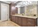 This main bathroom features a double vanity with a decorative stone countertop and hardwood cabinetry at 4317 Oglethorpe Nw Loop, Acworth, GA 30101