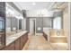 This main bathroom features a double vanity, tile floors, and a glass enclosed shower and tub at 4317 Oglethorpe Nw Loop, Acworth, GA 30101