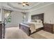 This main bedroom boasts a tray ceiling, neutral carpet, and large dark wood bed frame with matching furniture at 4317 Oglethorpe Nw Loop, Acworth, GA 30101