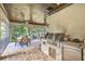 Inviting outdoor kitchen with stone floor, grill, and a dining area overlooking the landscape at 4317 Oglethorpe Nw Loop, Acworth, GA 30101