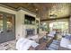 Covered outdoor living area with stone fireplace, ceiling fans and views of the backyard and neighborhood at 4317 Oglethorpe Nw Loop, Acworth, GA 30101