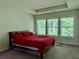 Bright bedroom featuring a tray ceiling, large windows with natural light, and a comfortable bed at 1452 Ridgebend Se Way, Mableton, GA 30126