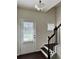 Bright entry foyer with dark wood staircase, white trim, and a door with window and blinds at 1452 Ridgebend Se Way, Mableton, GA 30126
