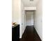 Long, well-lit hallway with dark wood floors and white walls leading to multiple rooms at 1452 Ridgebend Se Way, Mableton, GA 30126