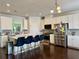 Spacious kitchen with white cabinets, stainless steel appliances, a large island, and barstool seating at 1452 Ridgebend Se Way, Mableton, GA 30126