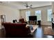 Cozy living room featuring a comfortable couch, fireplace, large windows, and ample natural light at 1452 Ridgebend Se Way, Mableton, GA 30126