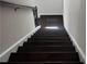 Dark wood staircase with white risers, offering a clear path to the upper level of the home at 1452 Ridgebend Se Way, Mableton, GA 30126