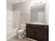 Bathroom with a wood vanity, large mirror, and shower-tub combination at 639 Ira Sw St, Atlanta, GA 30312