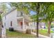 Side view of a beige two-story home with a welcoming front porch and green lawn at 639 Ira Sw St, Atlanta, GA 30312