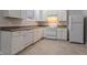 Well-lit kitchen features white appliances, light-colored cabinets, and coordinating countertops with tile flooring at 639 Ira Sw St, Atlanta, GA 30312