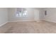 Spacious living room with neutral carpet, a window, and a white door at 639 Ira Sw St, Atlanta, GA 30312
