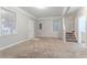 Open living area with natural light, carpet flooring, staircase and multiple entryways at 639 Ira Sw St, Atlanta, GA 30312