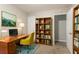 Home office with desk, ample shelving for books, and a comfortable green chair at 639 Ira Sw St, Atlanta, GA 30312