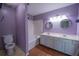 A dual sink vanity bathroom with a tub and toilet at 7472 Woods Ct, Lithonia, GA 30248