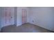 Bedroom featuring carpet flooring, white walls and two pink doors at 7472 Woods Ct, Lithonia, GA 30248