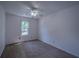 Bedroom with carpet flooring, a ceiling fan, and a window looking out onto the outside at 7472 Woods Ct, Lithonia, GA 30248
