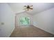 Carpeted bedroom featuring white walls, vaulted ceilings and a window with nature views at 7472 Woods Ct, Lithonia, GA 30248