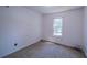 Bedroom with carpet flooring, white walls and a window bringing in natural light at 7472 Woods Ct, Lithonia, GA 30248