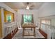 Virtually staged dining room featuring hardwood floors, a ceiling fan, and natural light from a window at 7472 Woods Ct, Lithonia, GA 30248