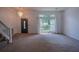 Bright entryway featuring a chandelier and a large window providing plenty of natural light at 7472 Woods Ct, Lithonia, GA 30248