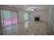 Bright living room features a fireplace, a ceiling fan, sliding glass doors to the outside deck, and tile flooring at 7472 Woods Ct, Lithonia, GA 30248