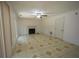 Spacious living room features a fireplace, a ceiling fan, window to the outside, and tile flooring at 7472 Woods Ct, Lithonia, GA 30248