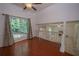Open living room with hardwood floors, large window, and easy access to the living room and outdoor deck at 7472 Woods Ct, Lithonia, GA 30248