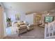 Bright, virtually staged living room with neutral furniture, large windows, and an adjacent dining area at 7472 Woods Ct, Lithonia, GA 30248