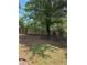 A spacious backyard with a mature tree and a newly installed fence, perfect for outdoor activities at 1120 Brandon Hill Way, Jonesboro, GA 30238