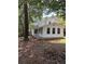View of the back of a two story home with a chimney and covered porch at 1120 Brandon Hill Way, Jonesboro, GA 30238