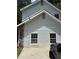 Charming two-story home featuring white siding, stone accents, and classic window designs at 1120 Brandon Hill Way, Jonesboro, GA 30238