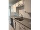 Kitchen sink with updated faucet, granite countertop, tile backsplash, and black dishwasher at 1120 Brandon Hill Way, Jonesboro, GA 30238