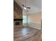 Living room with stone fireplace and accent wall, wood flooring, and ceiling fan at 1120 Brandon Hill Way, Jonesboro, GA 30238