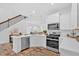 Bright, modern kitchen with stainless steel appliances and an island overlooking the living area at 2703 Jordan Ln, Lithia Springs, GA 30122
