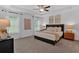 Spacious primary bedroom with tray ceilings, two windows and neutral décor at 2703 Jordan Ln, Lithia Springs, GA 30122