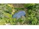 Aerial view of property with a pond with docks and firepit, surrounded by lush greenery at 3122 Harmony Rd, Temple, GA 30179