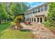 Backyard patio with dining set, ideal for al fresco dining, complemented by the serene outdoor view at 3122 Harmony Rd, Temple, GA 30179
