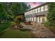 Backyard patio with dining set, perfect for enjoying outdoor meals, surrounded by lush greenery at 3122 Harmony Rd, Temple, GA 30179