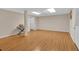 Spacious basement with hardwood floors, utility closet, stairs, and modern ceiling light at 3122 Harmony Rd, Temple, GA 30179