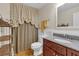 Stylish bathroom with granite vanity, hardwood floors, and unique shower curtain at 3122 Harmony Rd, Temple, GA 30179